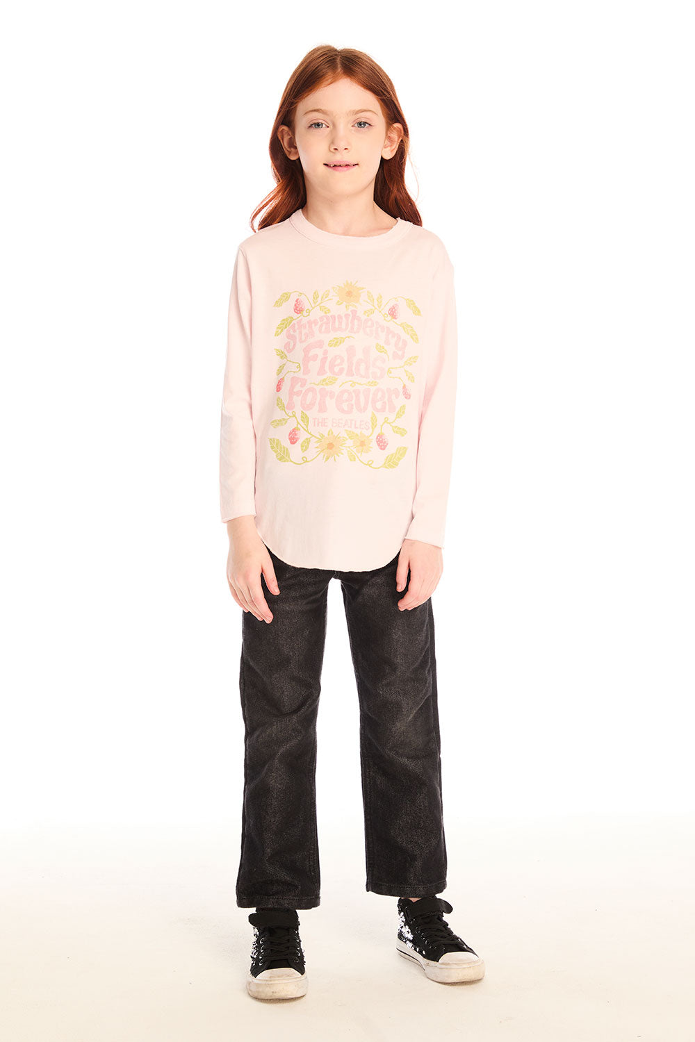Full body view of girl wearing Chaser’s light pink The Beatles Strawberry Fields Forever Long Sleeve with floral design and black pants on a white background