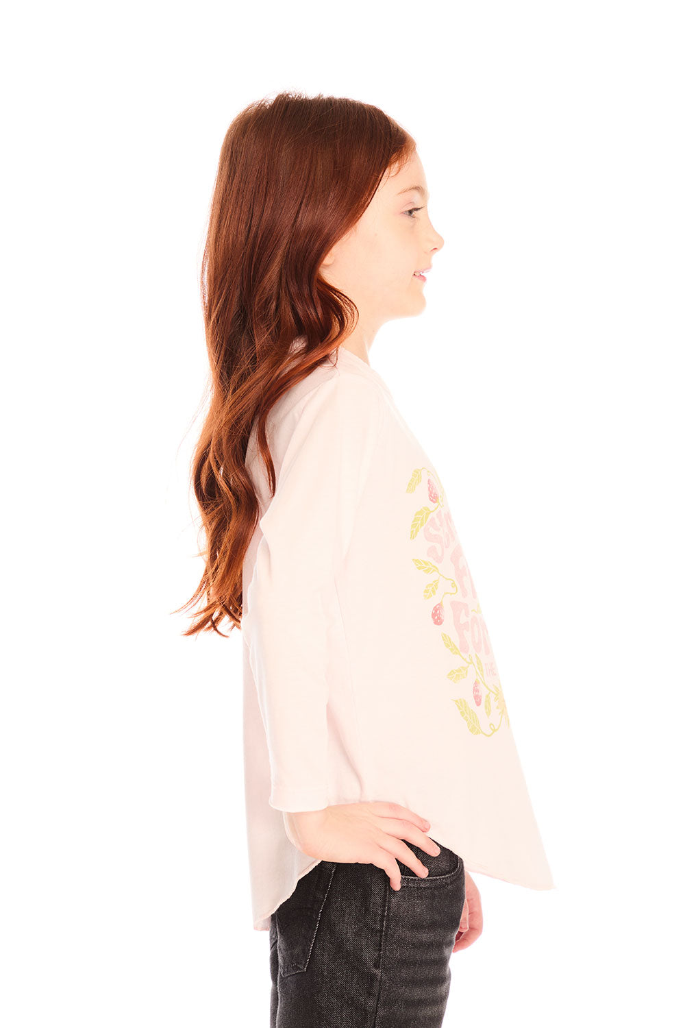 Side view of girl wearing Chaser’s light pink The Beatles Strawberry Fields Forever Long Sleeve with floral print on a white background