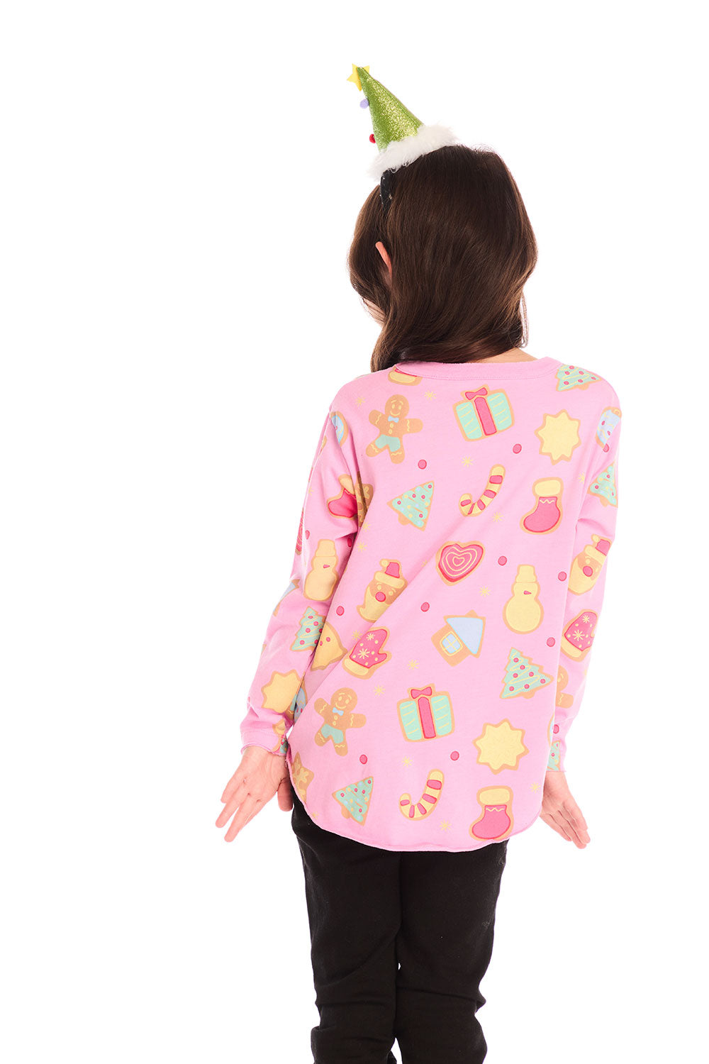 Back view of girl wearing Chaser’s pink Tossed Candy Canes Long Sleeve with allover candy cane design and a Christmas tree hat on a white background