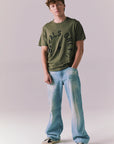 Full body of model wearing Locals Only tee in Backwoods Green.