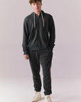 Full body view of model in Bolt Black Jogger Pants with matching hoodie.