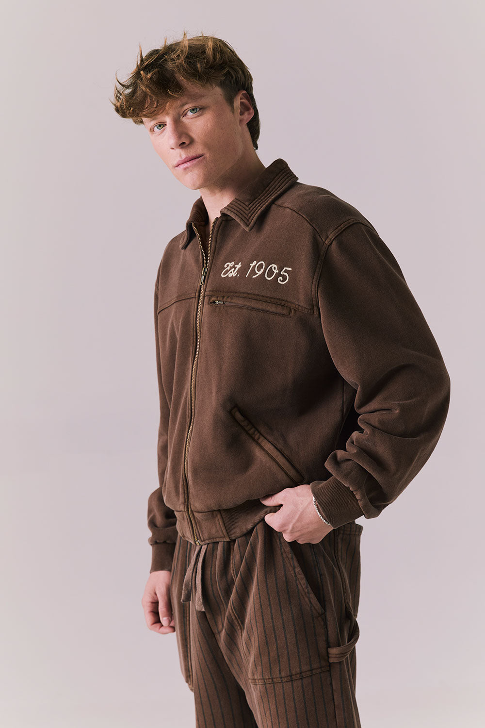 Side view of Est. 1905 Jacket showing athletic cut and contrast stripe.