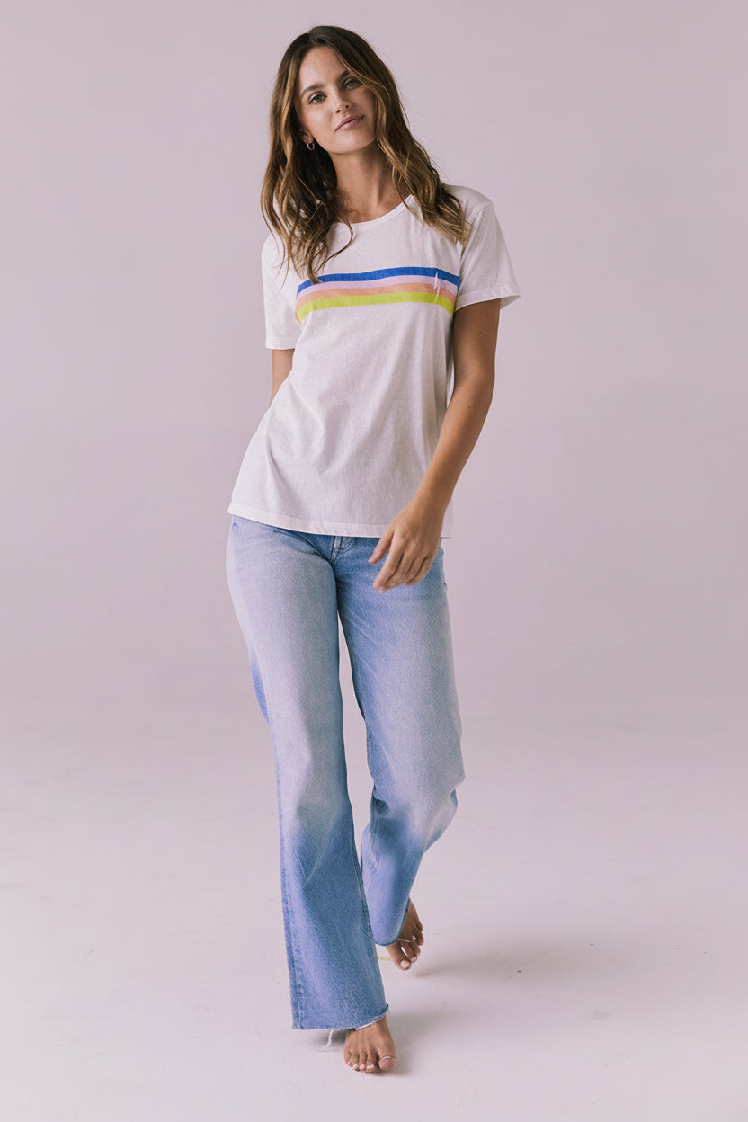 Full body view of the Chaser Retro Lightning Tee in White styled with light wash denim for a relaxed everyday look