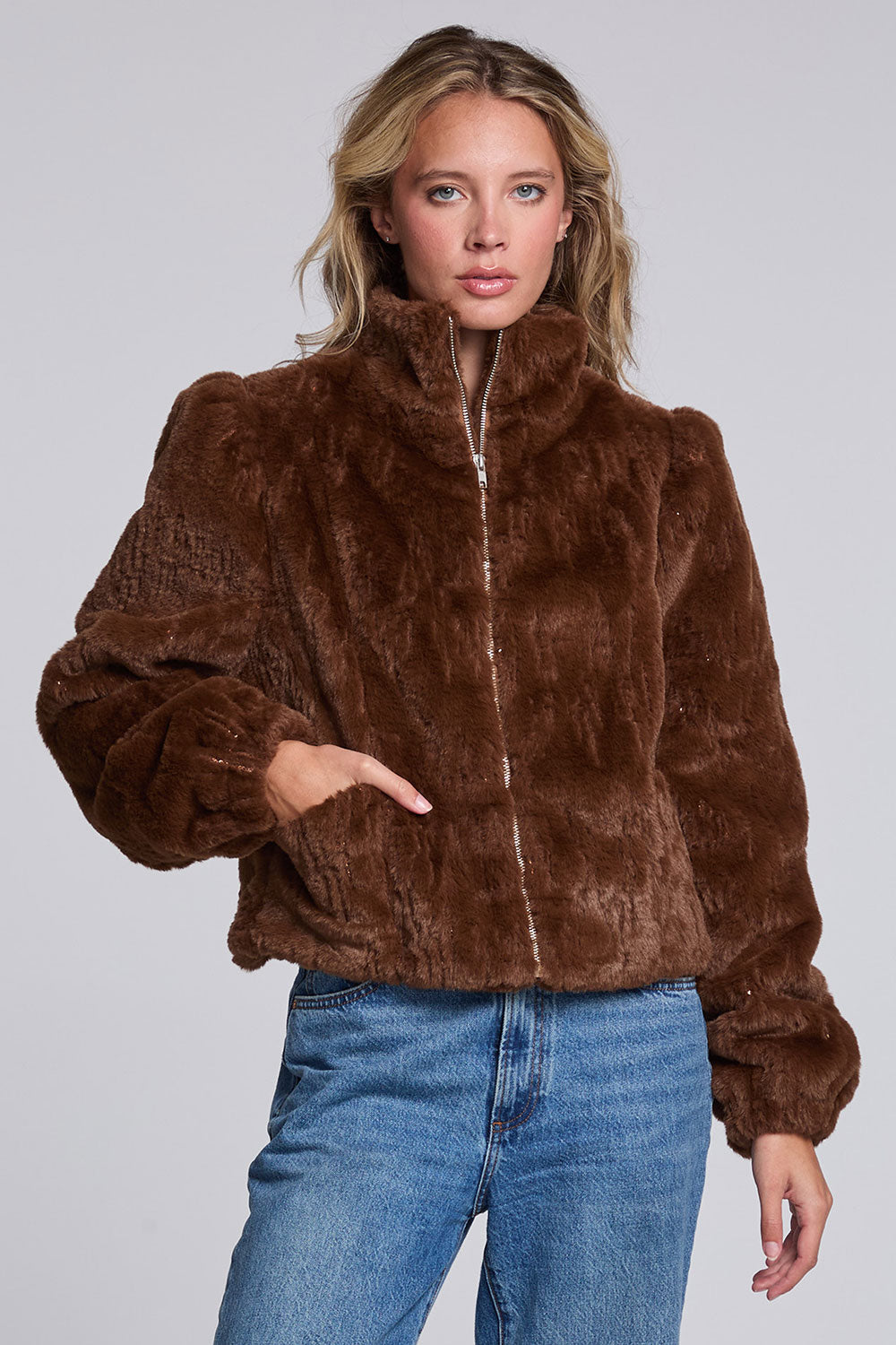 Model wearing Chaser's Dark Chocolate Puff Sleeve Jacket in deep brown plush faux-fur texture with oversized puff sleeves, front view