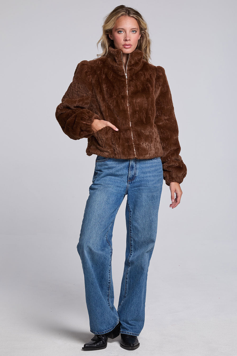 Model wearing Chaser's Dark Chocolate Puff Sleeve Jacket in deep brown plush faux-fur texture with oversized puff sleeves, full-body view