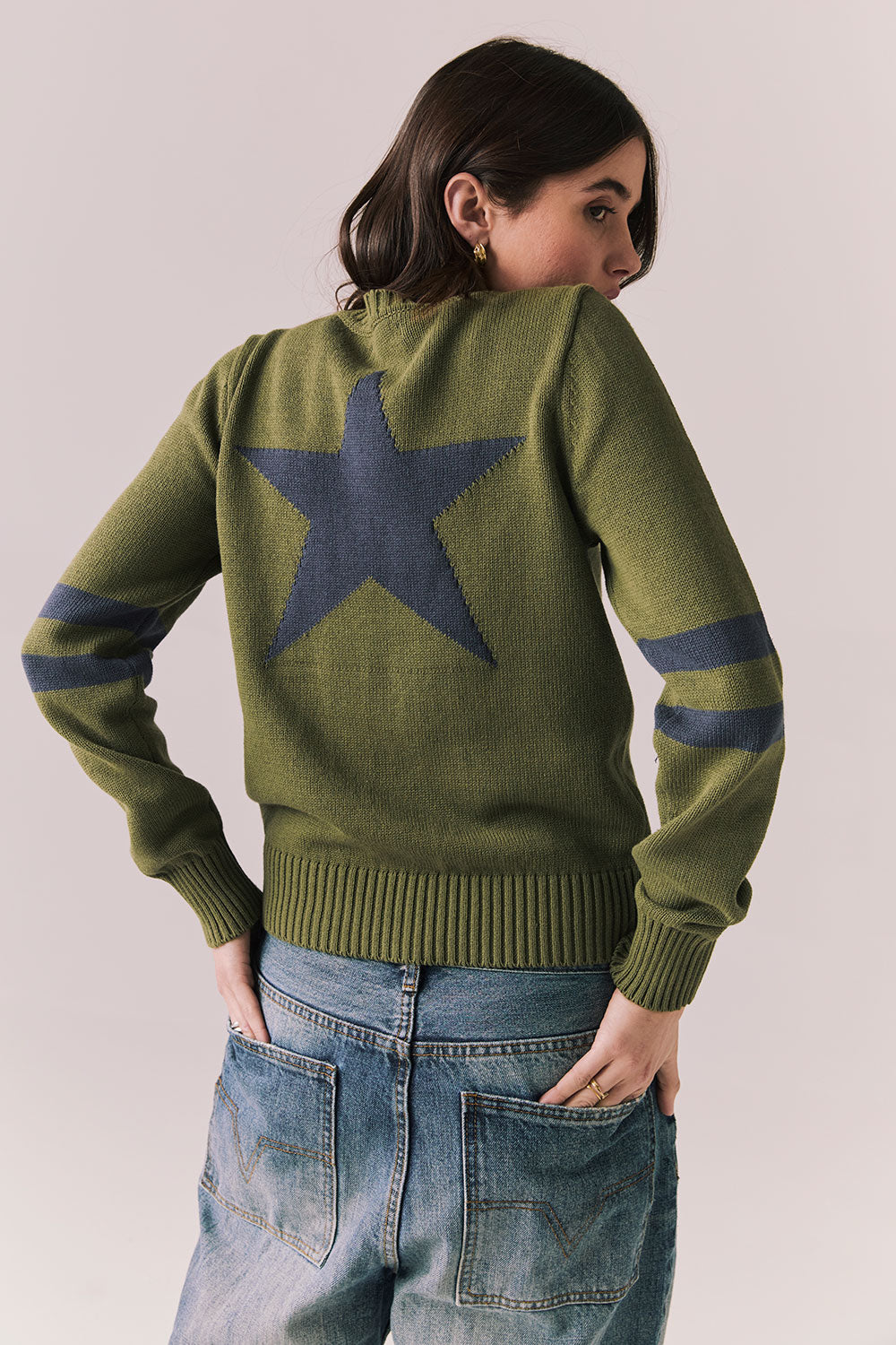 Back view of Varsity Star Sweater in bronze green with large star graphic centered between the shoulders against a plain background
