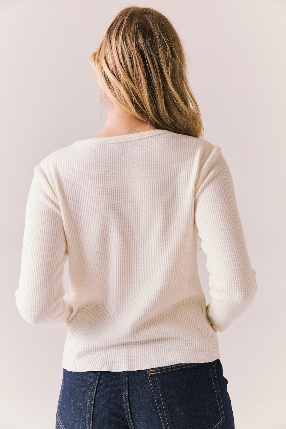 Back view of model wearing Aspen 1979 Long Sleeve in white