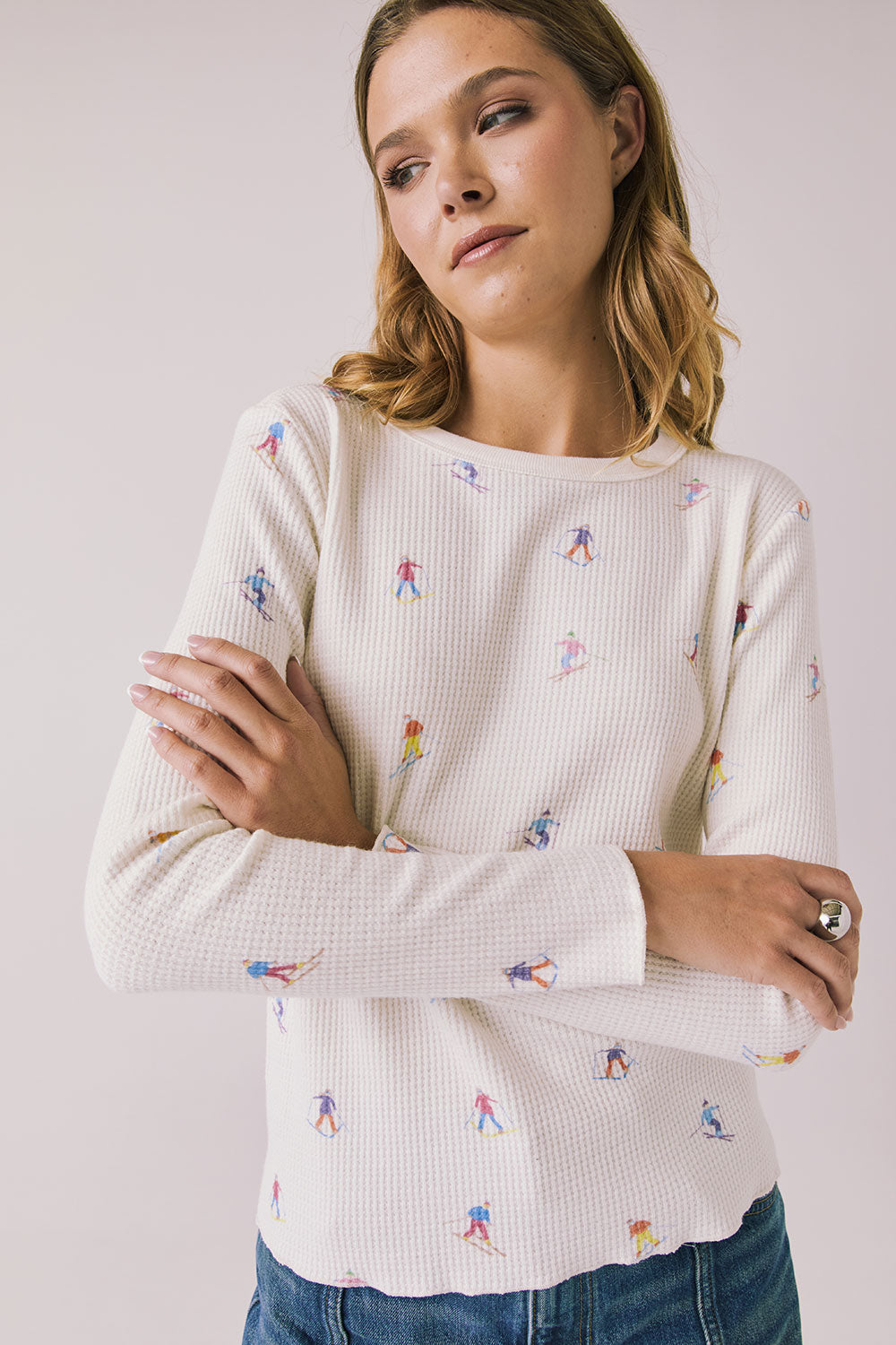 Woman wearing Chaser's Allover Skiers  with small colorful patterns on a light gray background