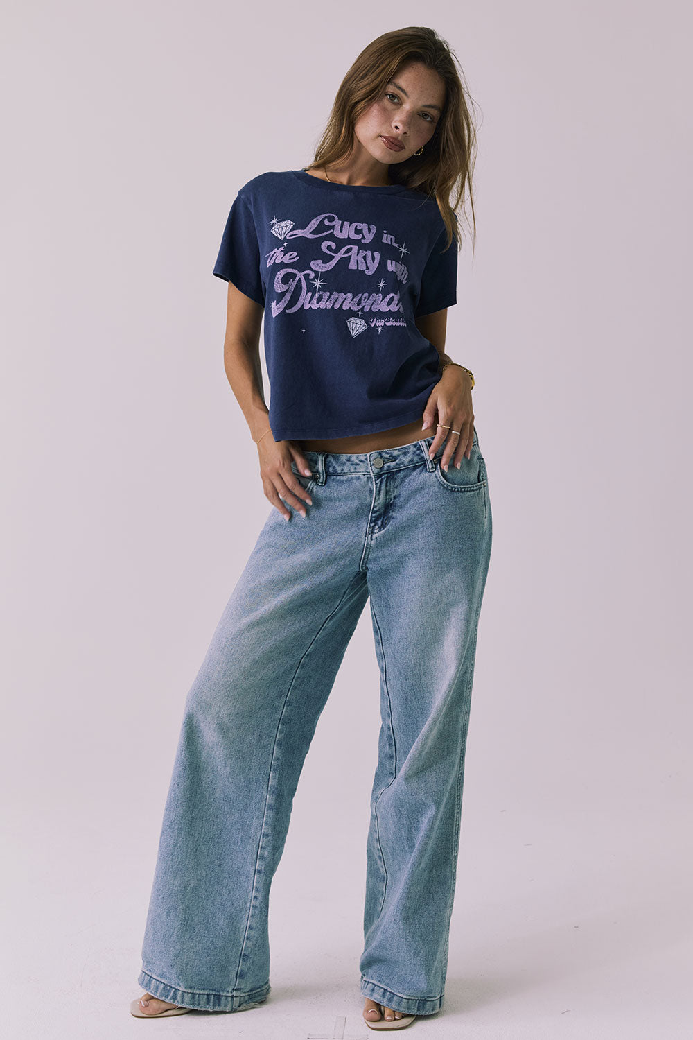 Full body view of the Chaser Lucy In The Sky With Diamonds Tee styled casually with denim for an everyday look