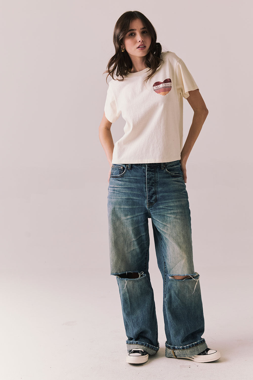 Full front view of Lake Tahoe Ombre Tee in starry white with soft gradient fade, heart-shaped graphic design, relaxed silhouette and blue jeans on a plain background