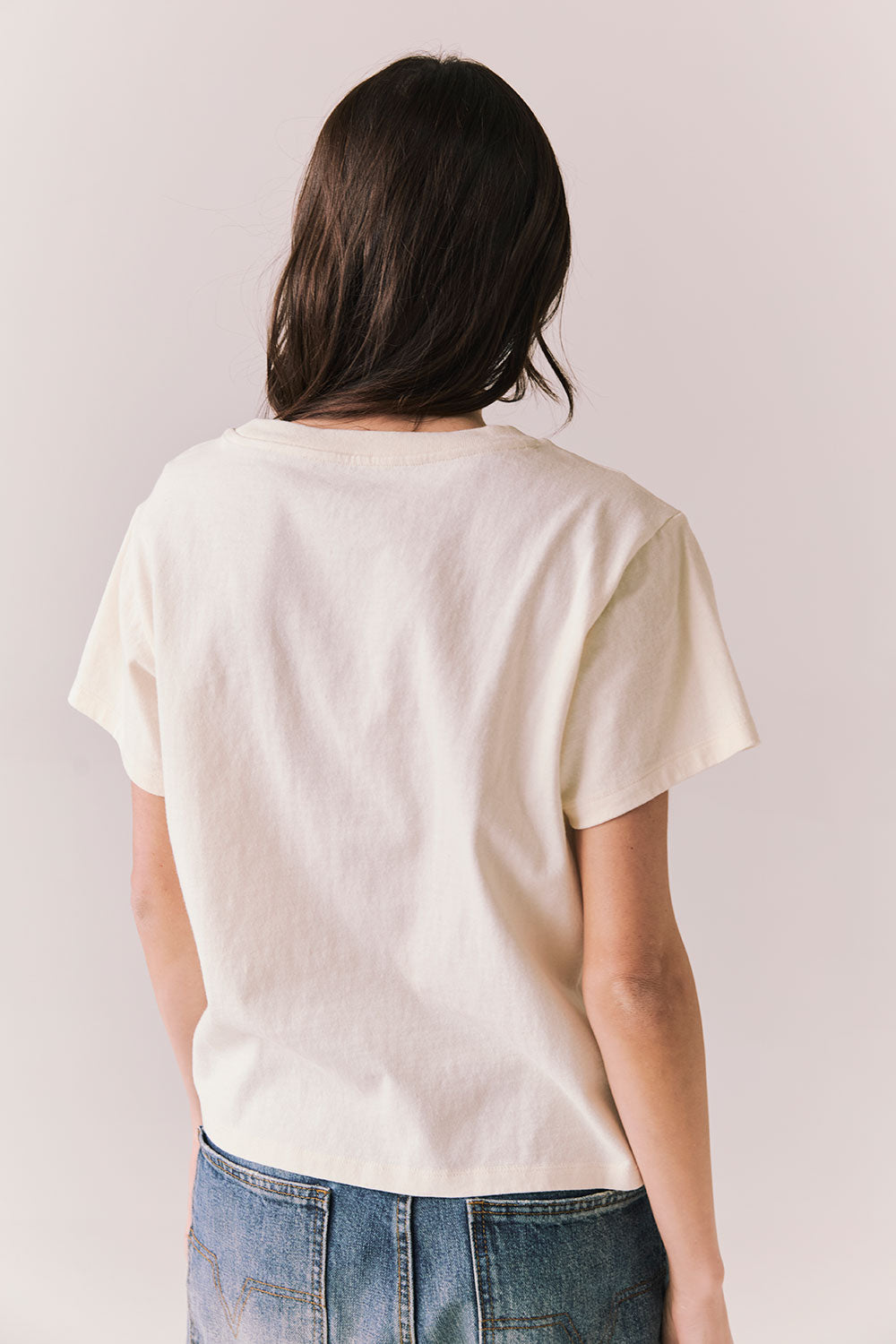 Back view of Lake Tahoe Ombre Tee in starry white with soft gradient fade, heart-shaped graphic design, and relaxed silhouette on a plain background