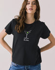 Front view of woman wearing Chaser’s black Tini Time Tee with martini glass graphic and “Tini Time” text on a plain background