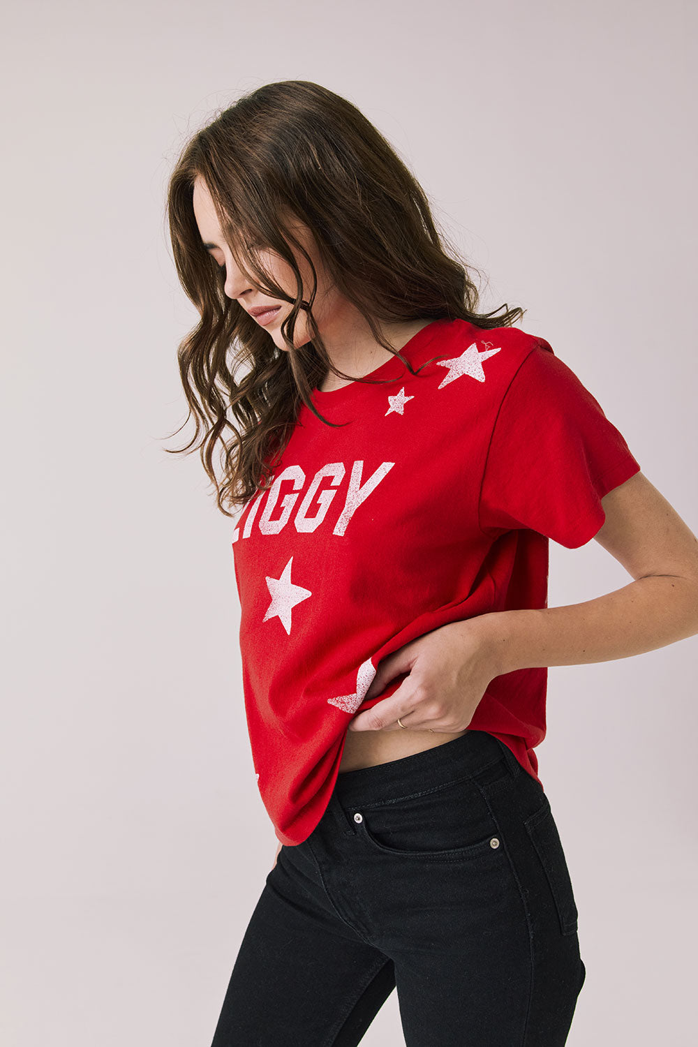 Side view of woman wearing Chaser’s Rouge Red David Bowie Ziggy Stardust Tee with relaxed fit on a light gray background (Licensed band collaboration — features official David Bowie branding for SEO relevance)