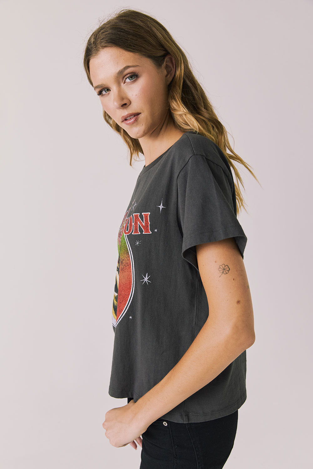Side view of woman wearing Chaser’s Willie Nelson Willie Christmas Tee showing vintage-style holiday print detail on a plain background (licensed band collaboration)