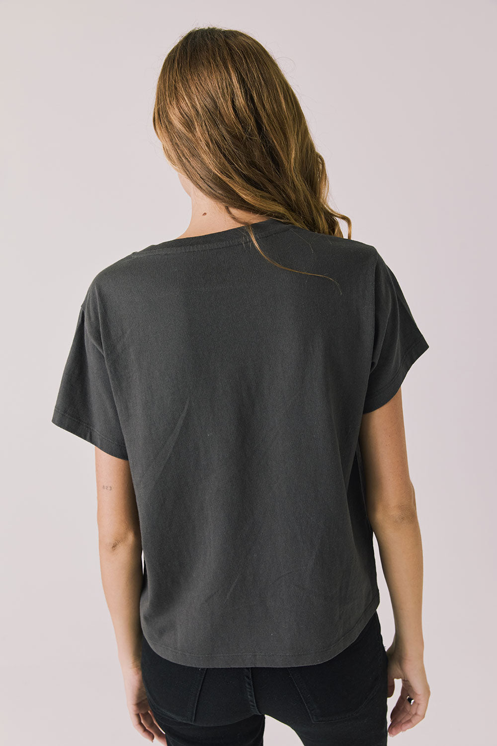 Back view of woman wearing Chaser’s Willie Nelson Willie Christmas Tee on a plain background (licensed band collaboration)