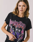Front view of woman wearing Chaser’s The Rolling Stones The British Are Coming Tee in True Black with Union Jack, band logo, and band member graphics on a plain background