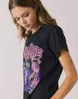 Side view of woman wearing Chaser’s The Rolling Stones The British Are Coming Tee in True Black on a plain background