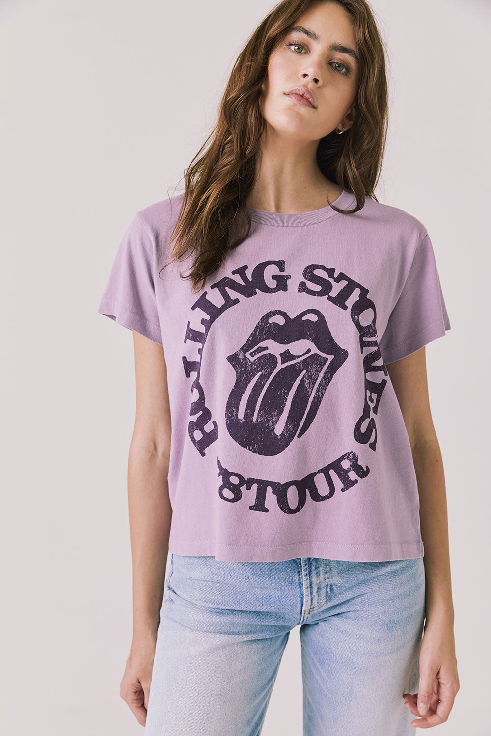 Front view of woman wearing Chaser’s The Rolling Stones ’78 Tour Amethyst Purple Tee on a plain background