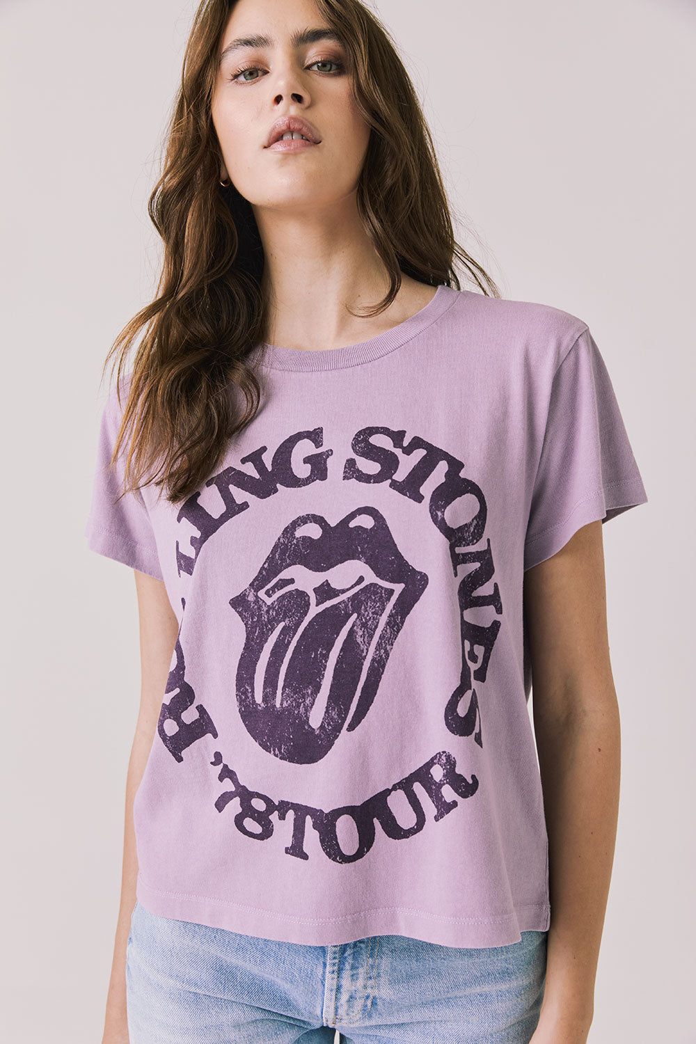 Front view of woman wearing Chaser’s The Rolling Stones ’78 Tour Amethyst Purple Tee on a plain background