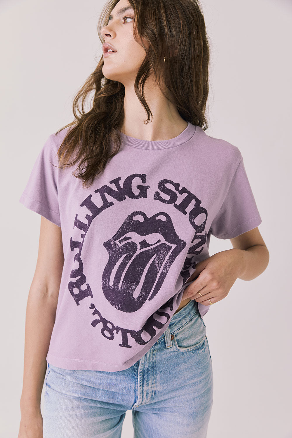 Front view of woman wearing Chaser’s The Rolling Stones ’78 Tour Amethyst Purple Tee on a plain background