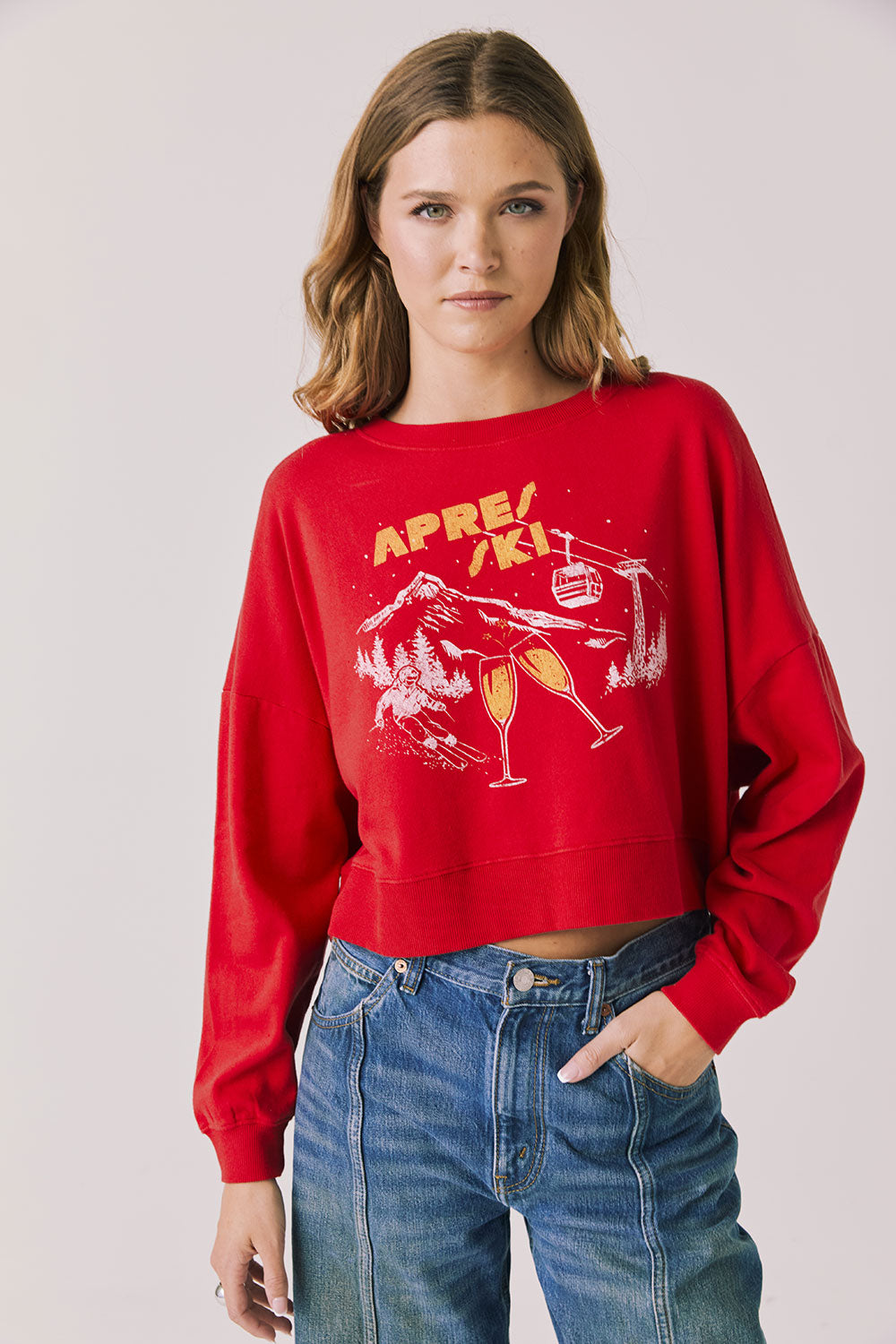 Woman wearing Chaser's red Apres Ski Cheers with graphic design on a plain background