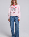 Model wearing Chaser's Champagne Party Pullover in Pinky pink with festive champagne glass artwork, full-body view