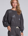 Model wearing Chaser's Holiday Cheer Pullover in Fresh Gravel with scattered holiday icons, angled view