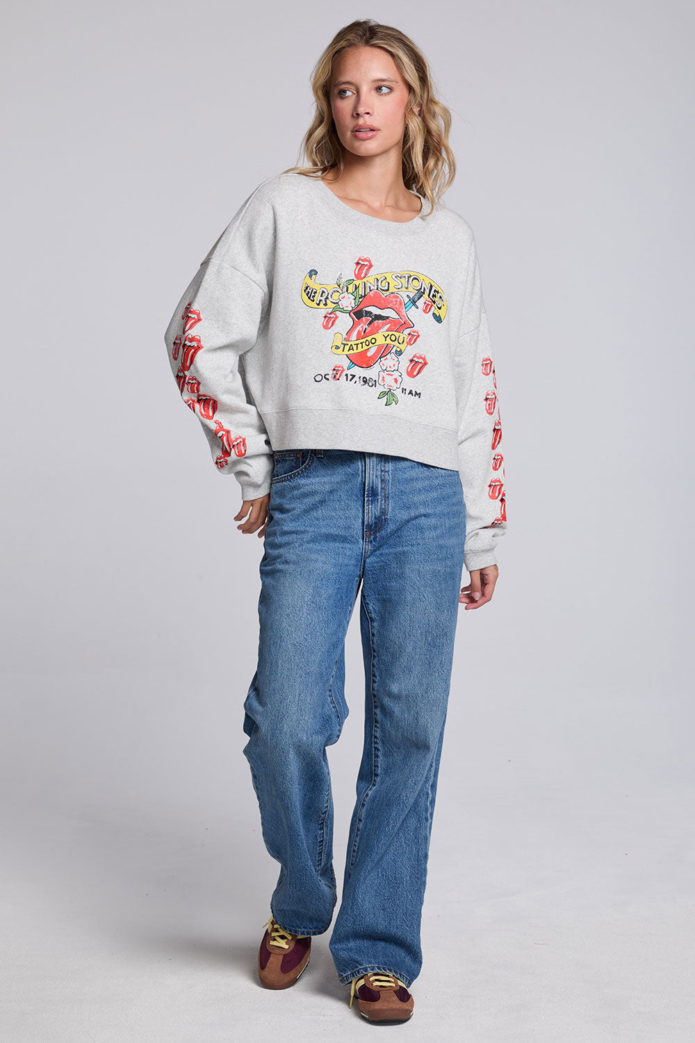 Model wearing Chaser's Rolling Stones Tattoo You Pullover in Heather Grey with colorful Rolling Stones Tattoo You artwork and red sleeve graphics, full-body view
