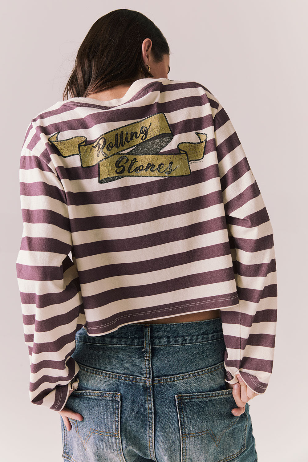 Back view of The Rolling Stones Rugby Stones Logo Long Sleeve with red and white stripes, cropped fit, and Rolling Stones graphic against a plain background