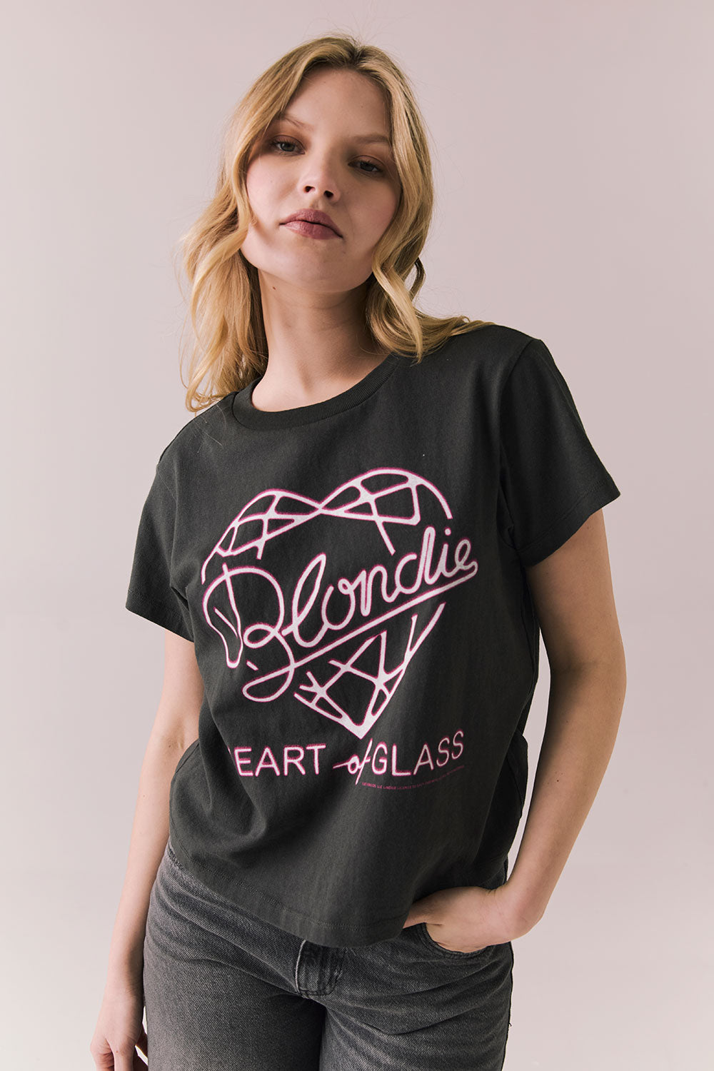 Front view of Blondie Heart of Glass black t-shirt with pink text and design on a plain background