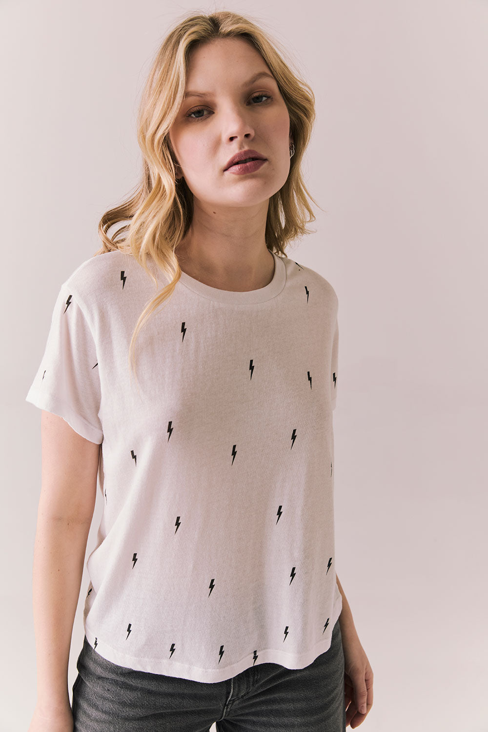 Front view of Tossed Bolts short sleeve tee in white with scattered black lightning bolt graphic and relaxed fit against a plain background