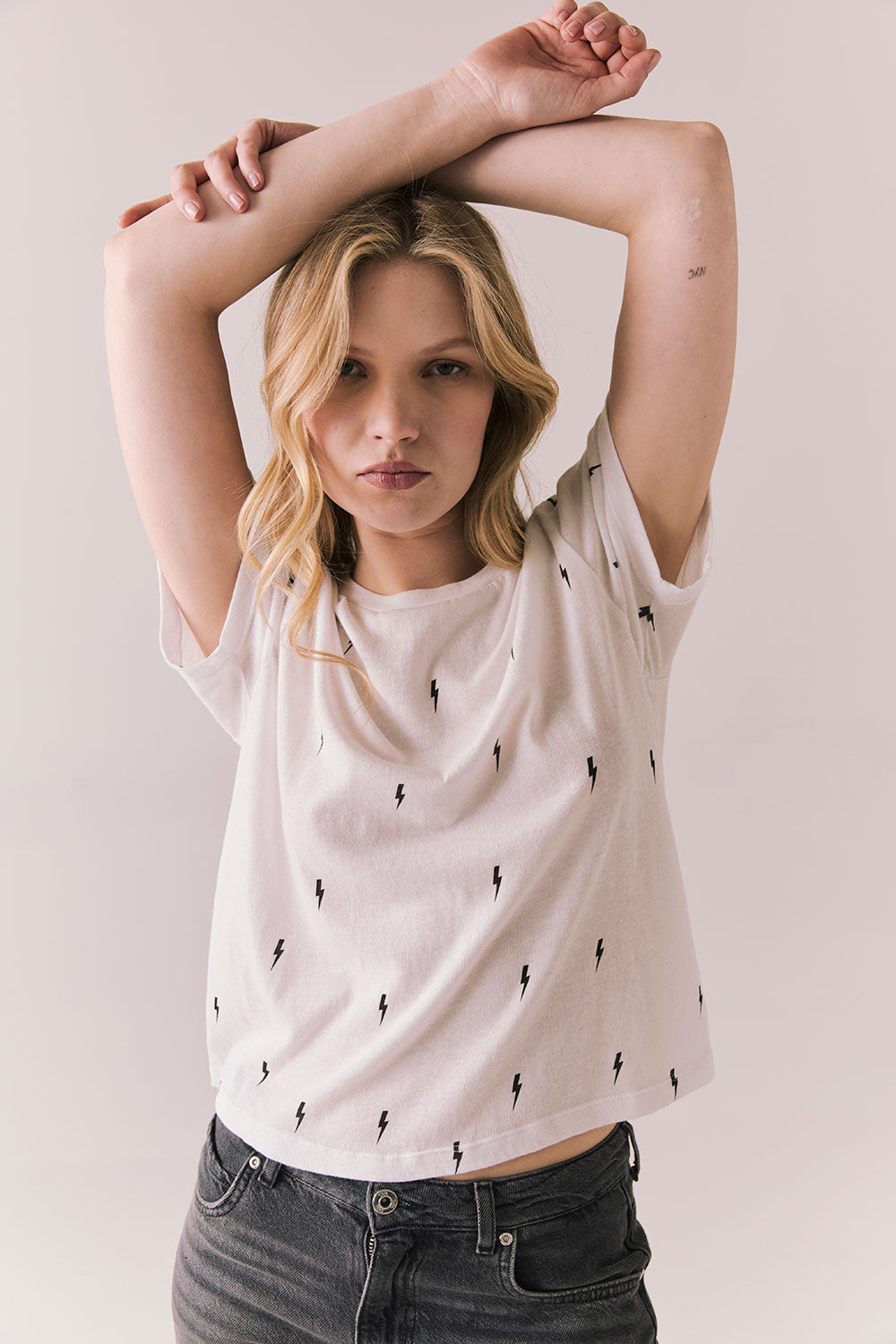 Front view of Tossed Bolts short sleeve tee in white with scattered black lightning bolt graphic and relaxed fit against a plain background
