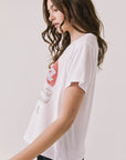 Side view of woman wearing Chaser's white Rome-inspired t-shirt with red heart and “Roma Italia” text on a light background
