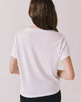 Back view of woman wearing Chaser's white “Roma Italia” Italian graphic tee on a light background