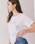 Side view of woman wearing the Airplane Mode Tee with blue text on a plain background