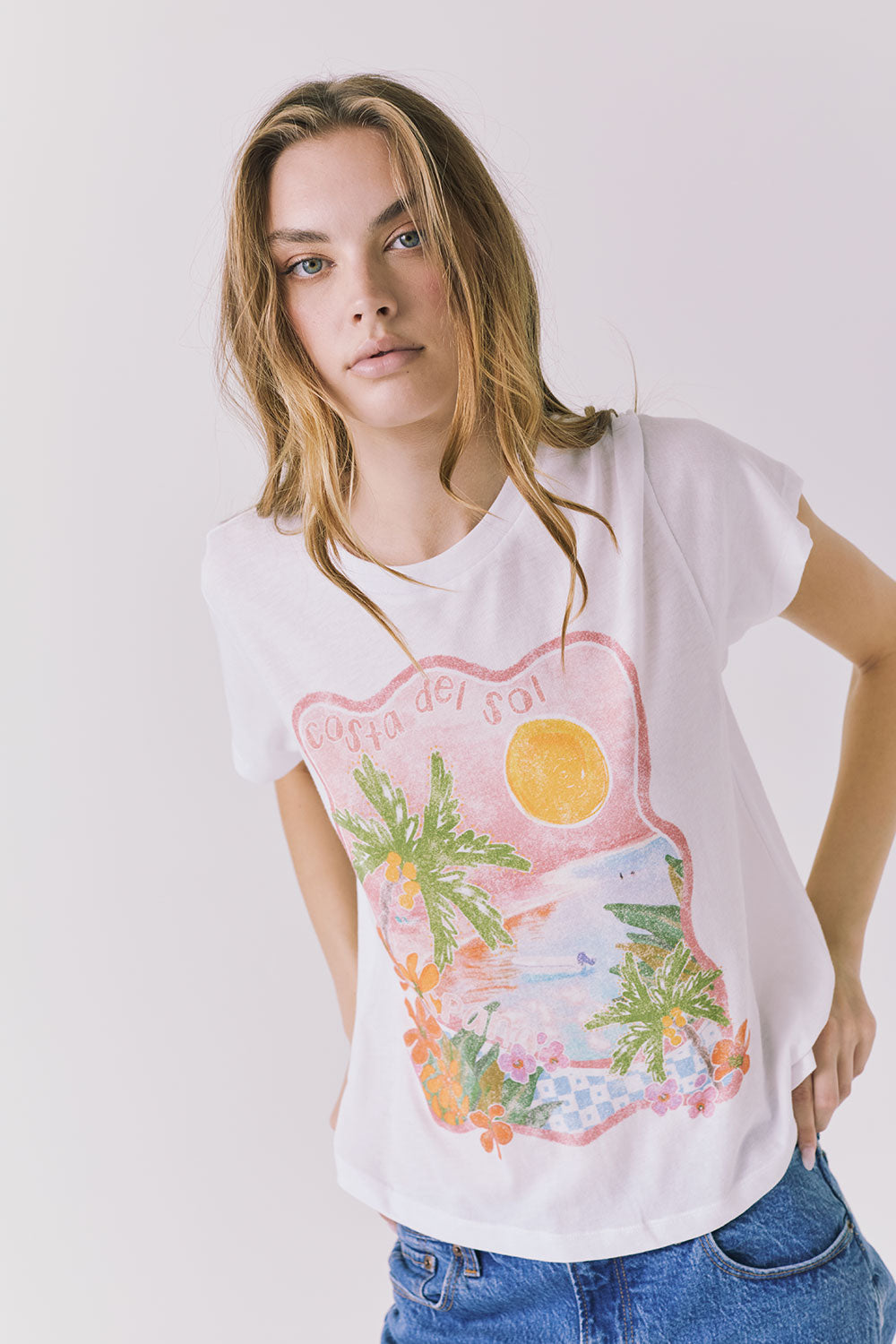 Angled front view of the Chaser Costa Del Sol Tee in White showing the vintage-inspired Costa Del Sol graphic and lightweight drape