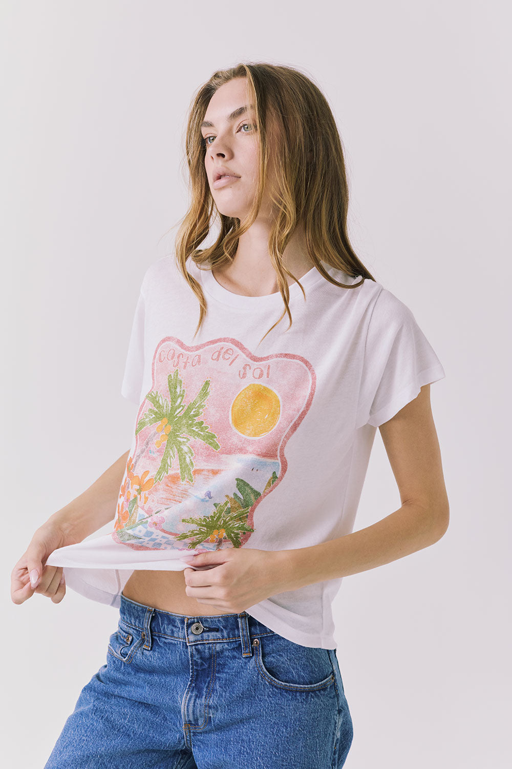 Side view of the Chaser Costa Del Sol Tee in White highlighting the easy fit, rolled sleeves, and soft jersey fabric