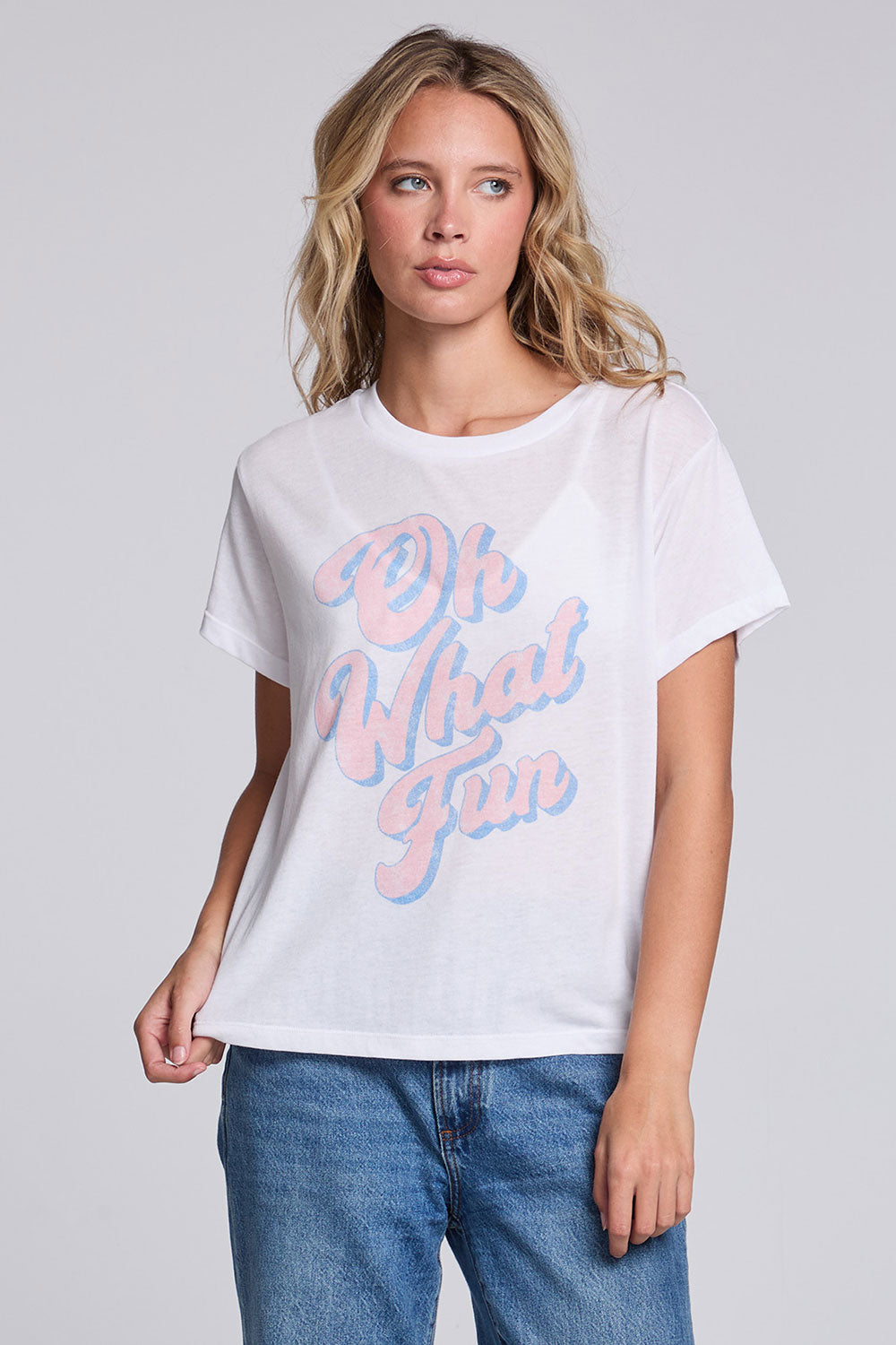Model wearing Chaser's Oh What Fun Tee in White with pastel Oh What Fun holiday lettering, front view