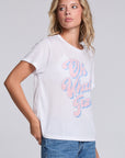 Model wearing Chaser's Oh What Fun Tee in White with pastel Oh What Fun holiday lettering, angled view