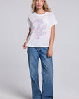Model wearing Chaser's Oh What Fun Tee in White with pastel Oh What Fun holiday lettering, full-body view