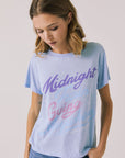 Front view of woman wearing Chaser’s Journey Midnight Train Light Blue Tee with “Midnight Going” text on a plain background