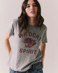 Front view of model wearing Wildcat Spirit Tee in Heather Grey with maroon wildcat chest graphic against a plain background
