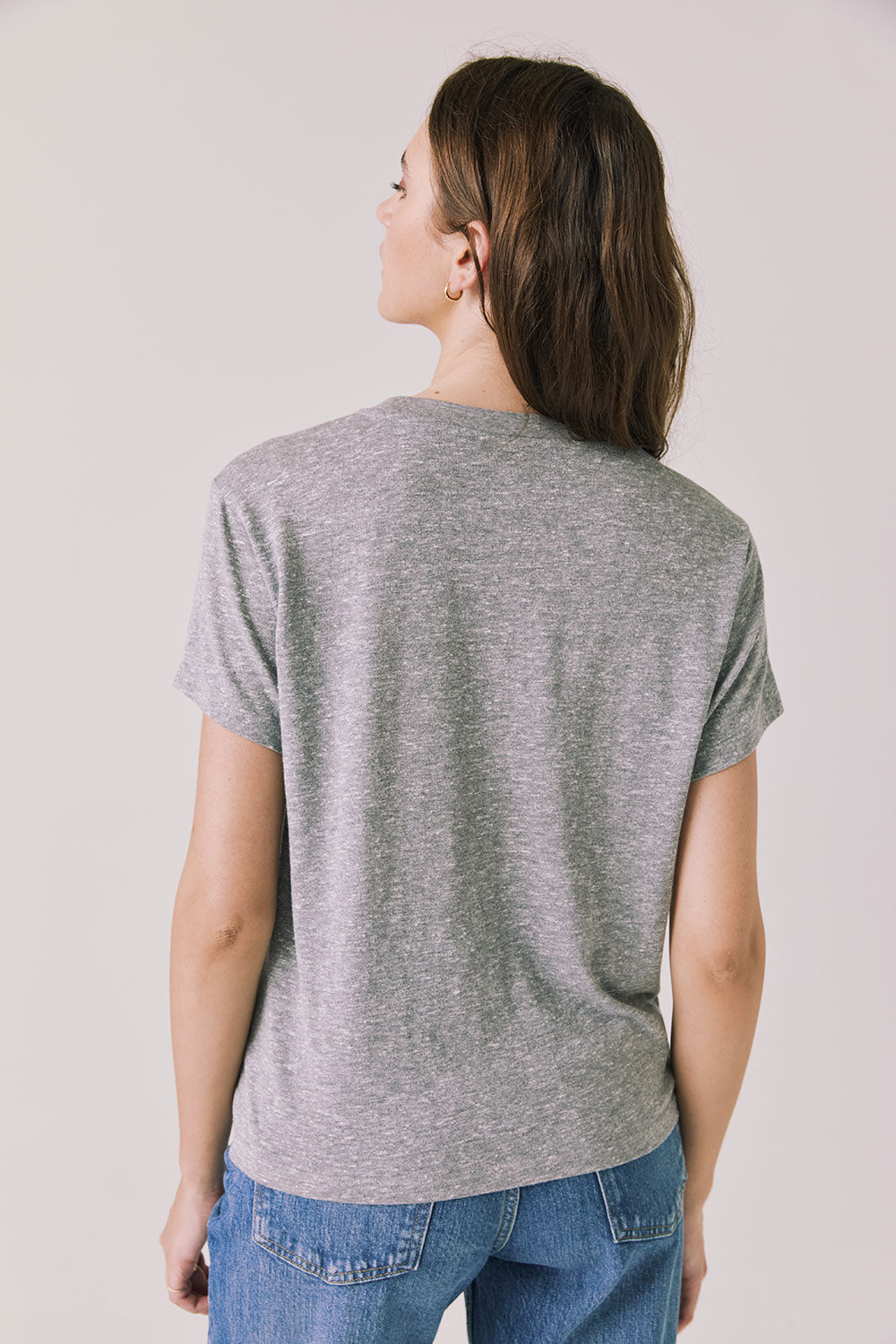 Back view of woman wearing Chaser’s Streaky Grey Love Tee on a white background
