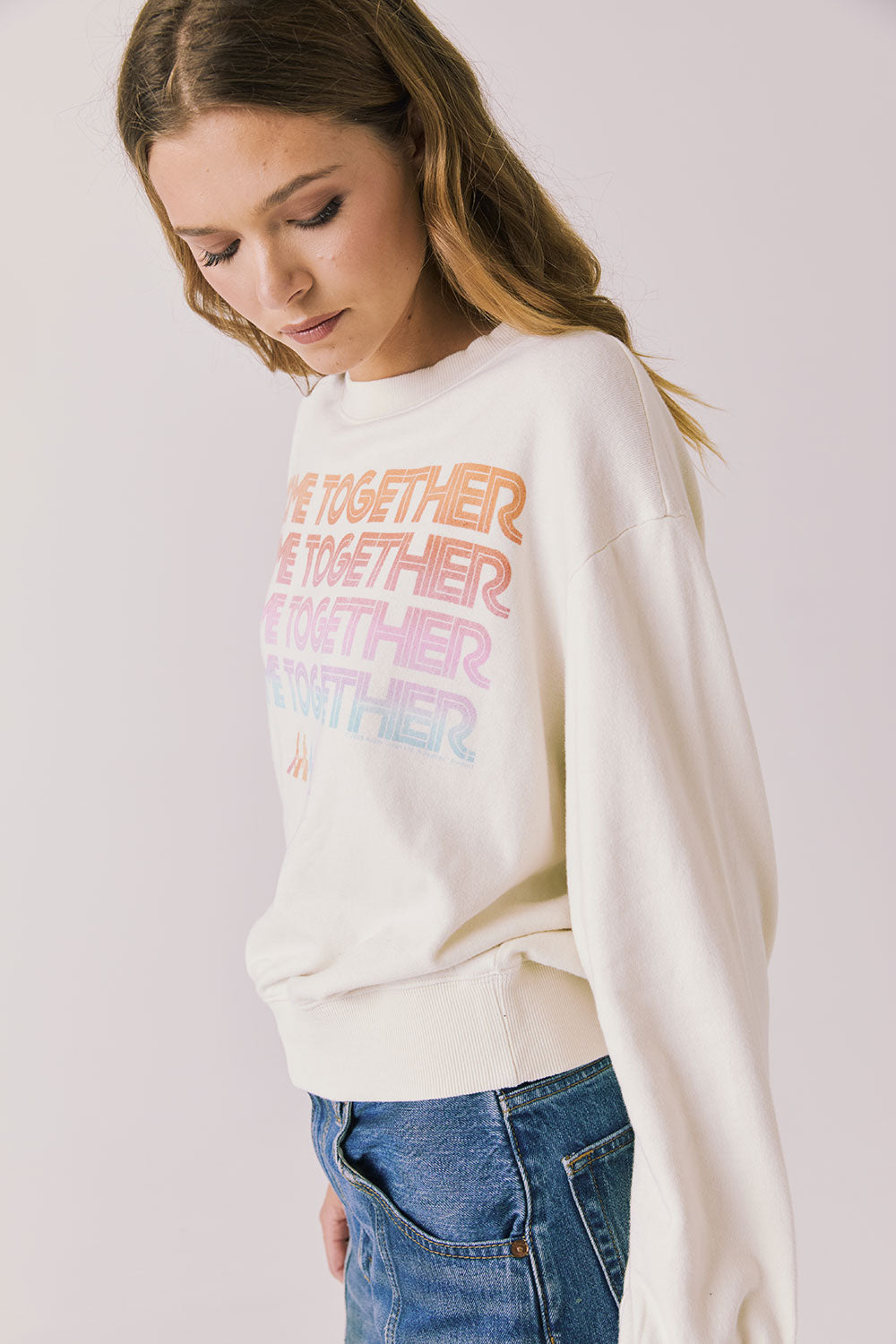 Side view of woman wearing Chaser’s The Beatles Come Together Starry White Long Sleeve on a plain background