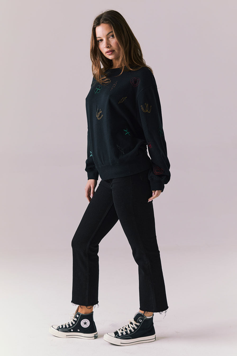 Side full body view of model in Allover Icons Long Sleeve in black