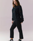 Side full body view of model in Allover Icons Long Sleeve in black