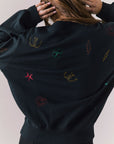 Back view of model wearing Allover Icons Long Sleeve in black