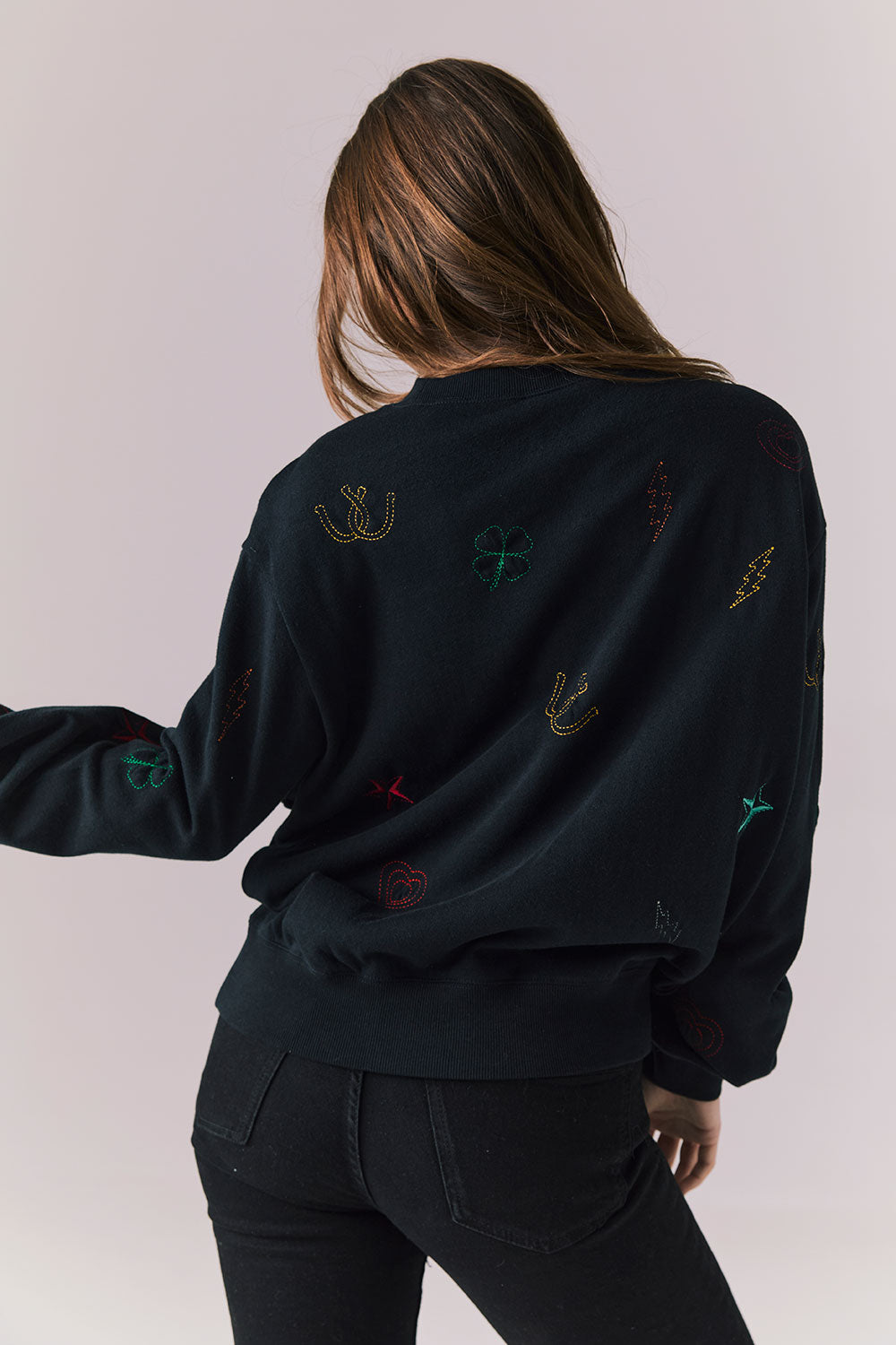 Back view of model wearing Allover Icons Long Sleeve in black
