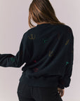 Back view of model wearing Allover Icons Long Sleeve in black