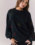 Front view of model wearing Allover Icons Long Sleeve in black